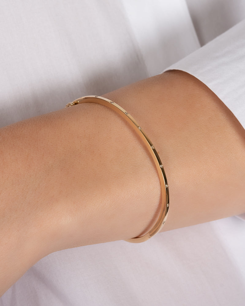Gold bracelet on a wrist 